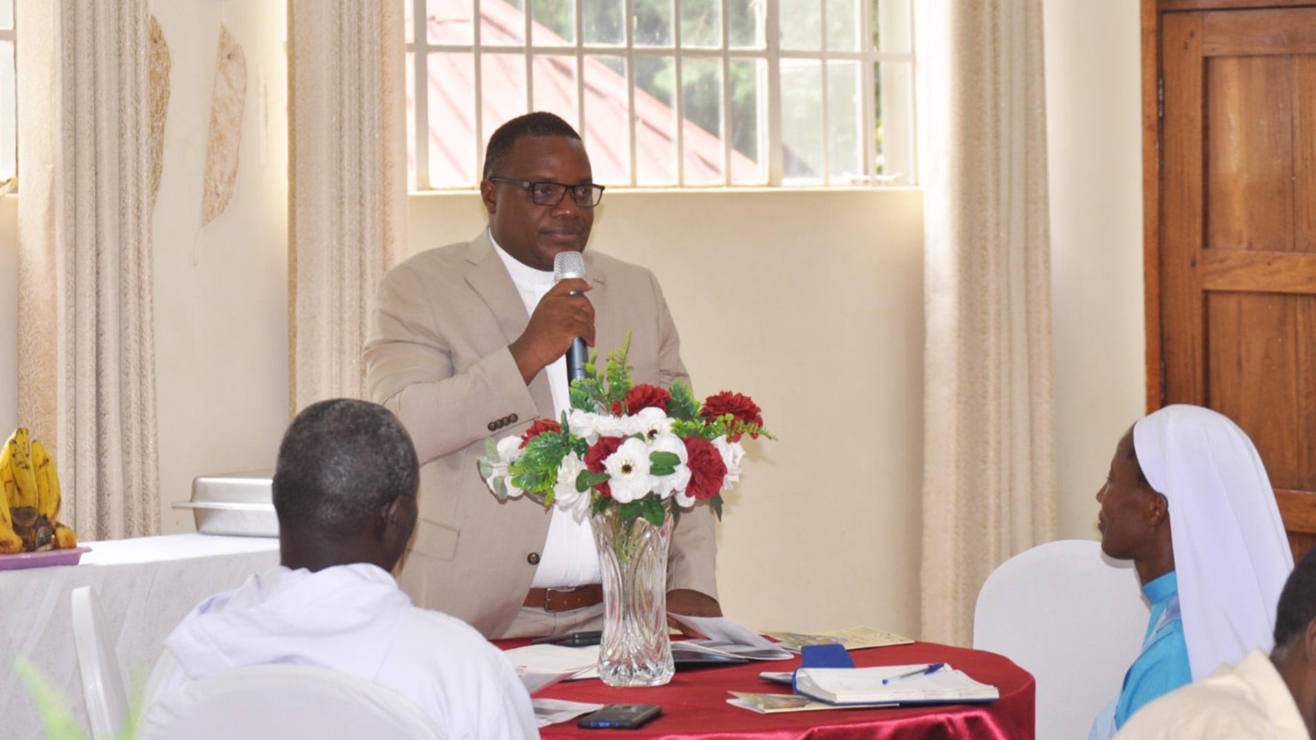 The Charities Department Lead speaking at a department gathering. Credit: Caritas Kampala.